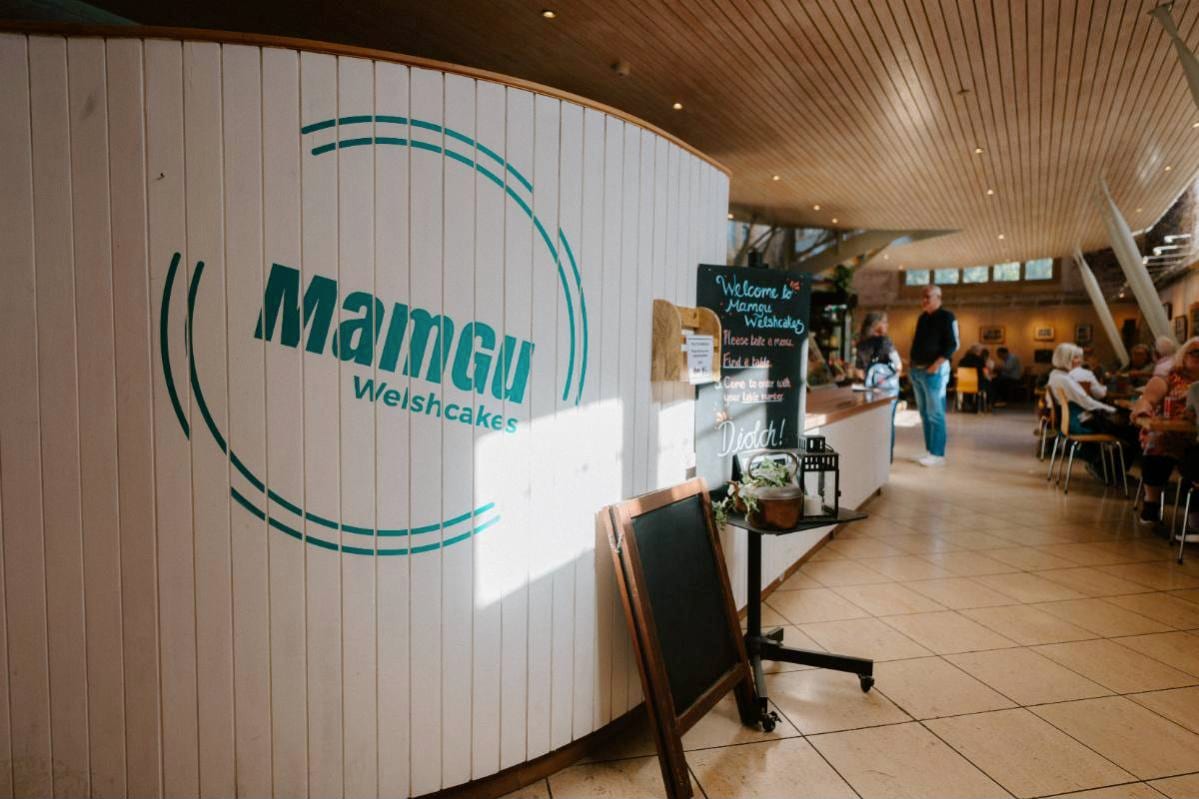 The MamGu Welshcakes counter at the Cathedral Refectory, St Davids, with the café tables beyond